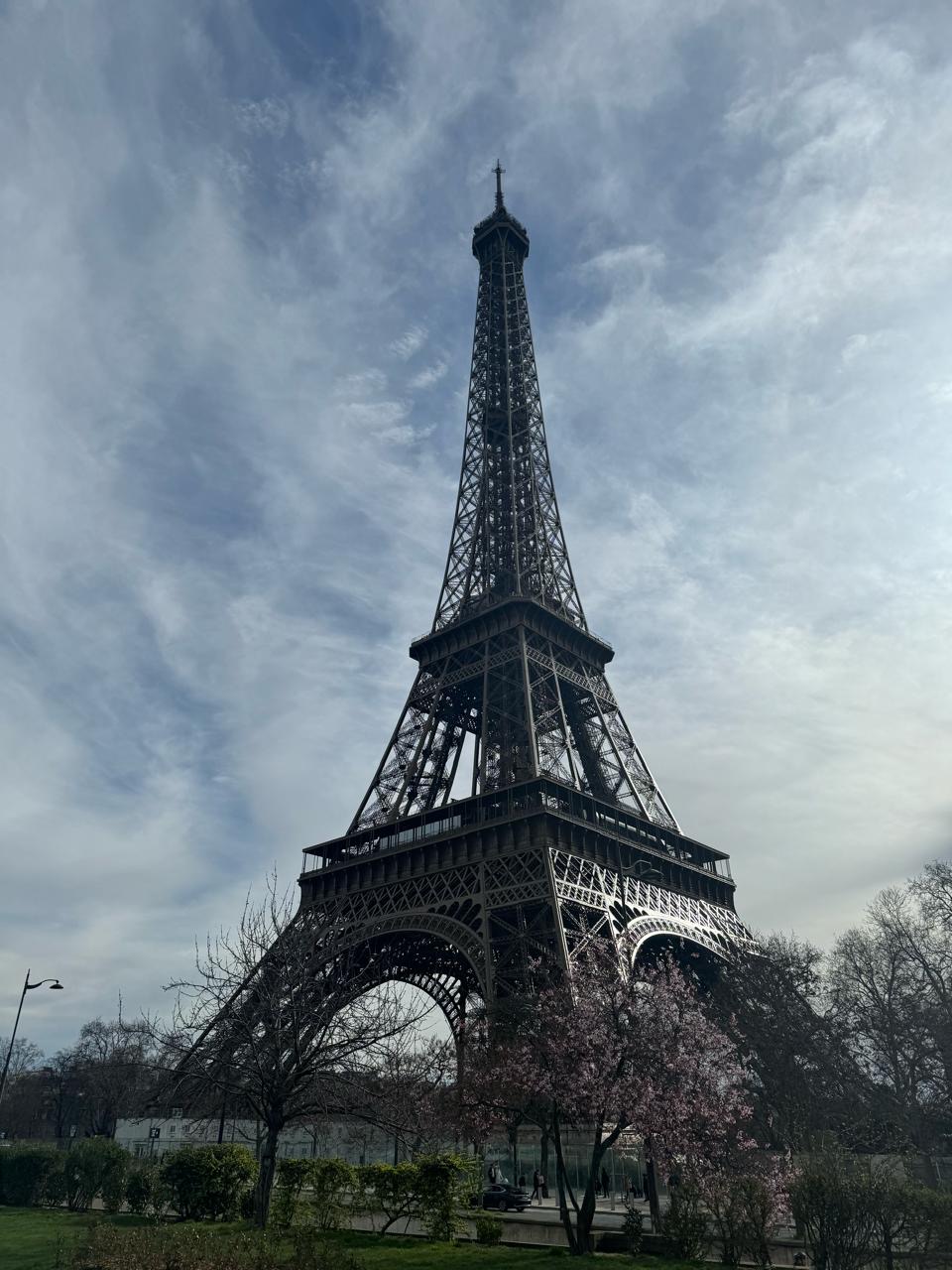 Eiffel Tower beneath textured clouds